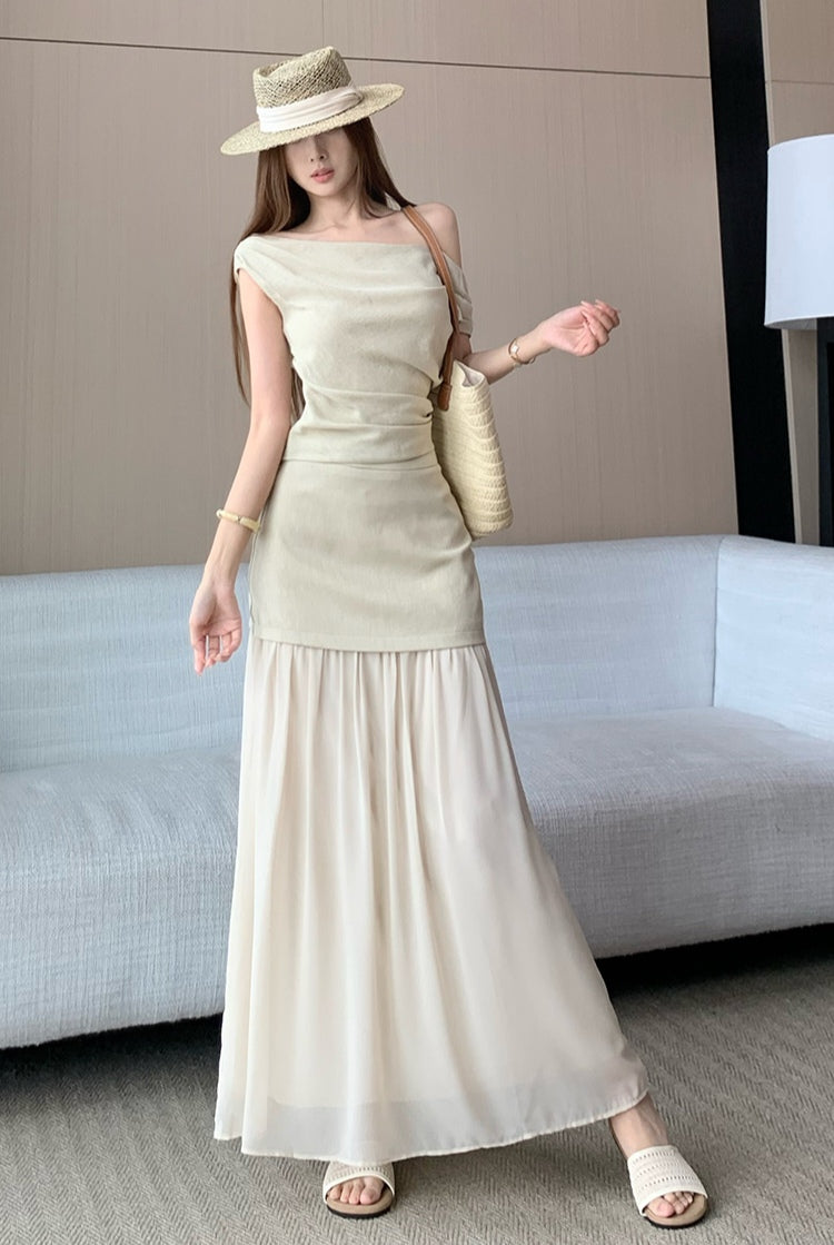 Elegant and sophisticated two-piece suit set, featuring a fitted Top a delicate off-the-shoulder design
