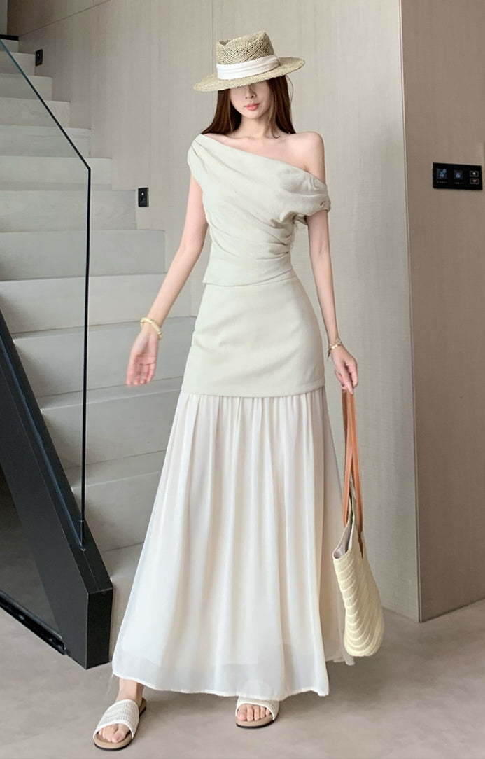 Elegant and sophisticated two-piece suit set, featuring a fitted Top a delicate off-the-shoulder design